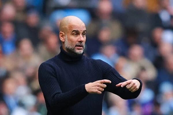 Guardiola coy on  title hopes as Man City hunt down Arsenal